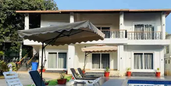 the resort in Karjat for family vacations, surrounded by lush greenery and scenic mountain views.